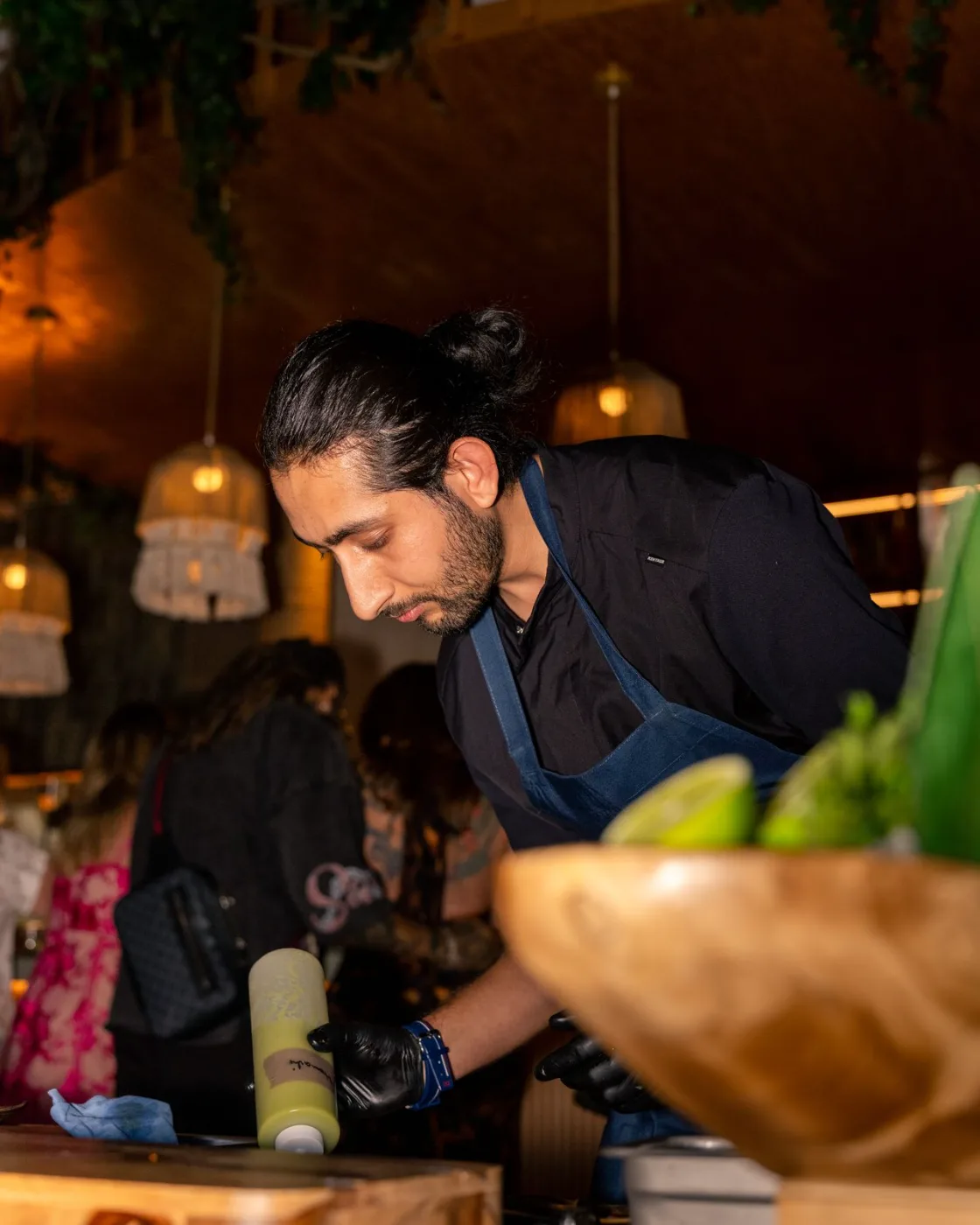 Chef at work behind the green-tiled pass at Esquina No. 525, Asbury Park