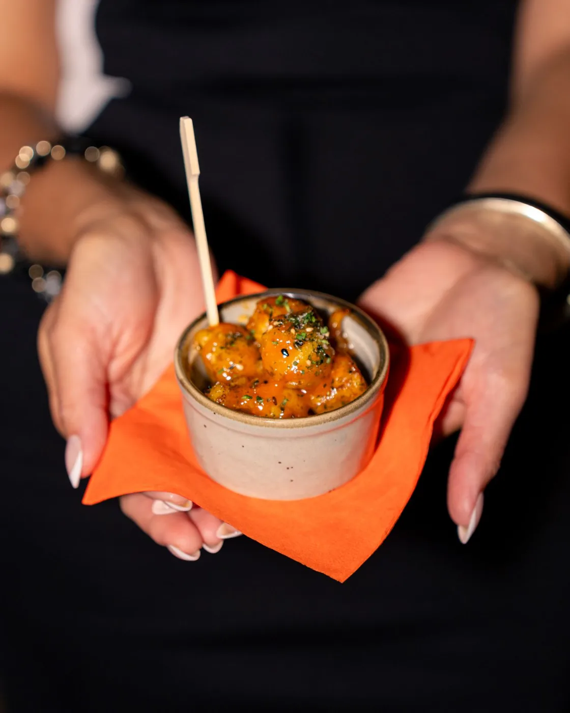 Para picar: glazed bites served in a ceramic cup at Esquina No. 525