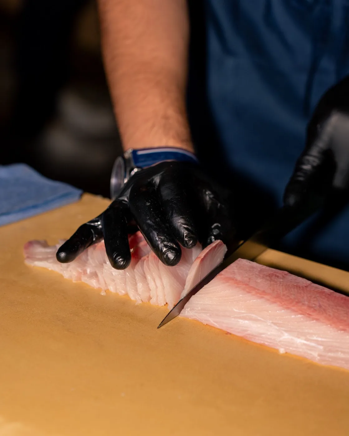 Slicing a yellowtail fillet with a Japanese knife for Nikkei tiradito