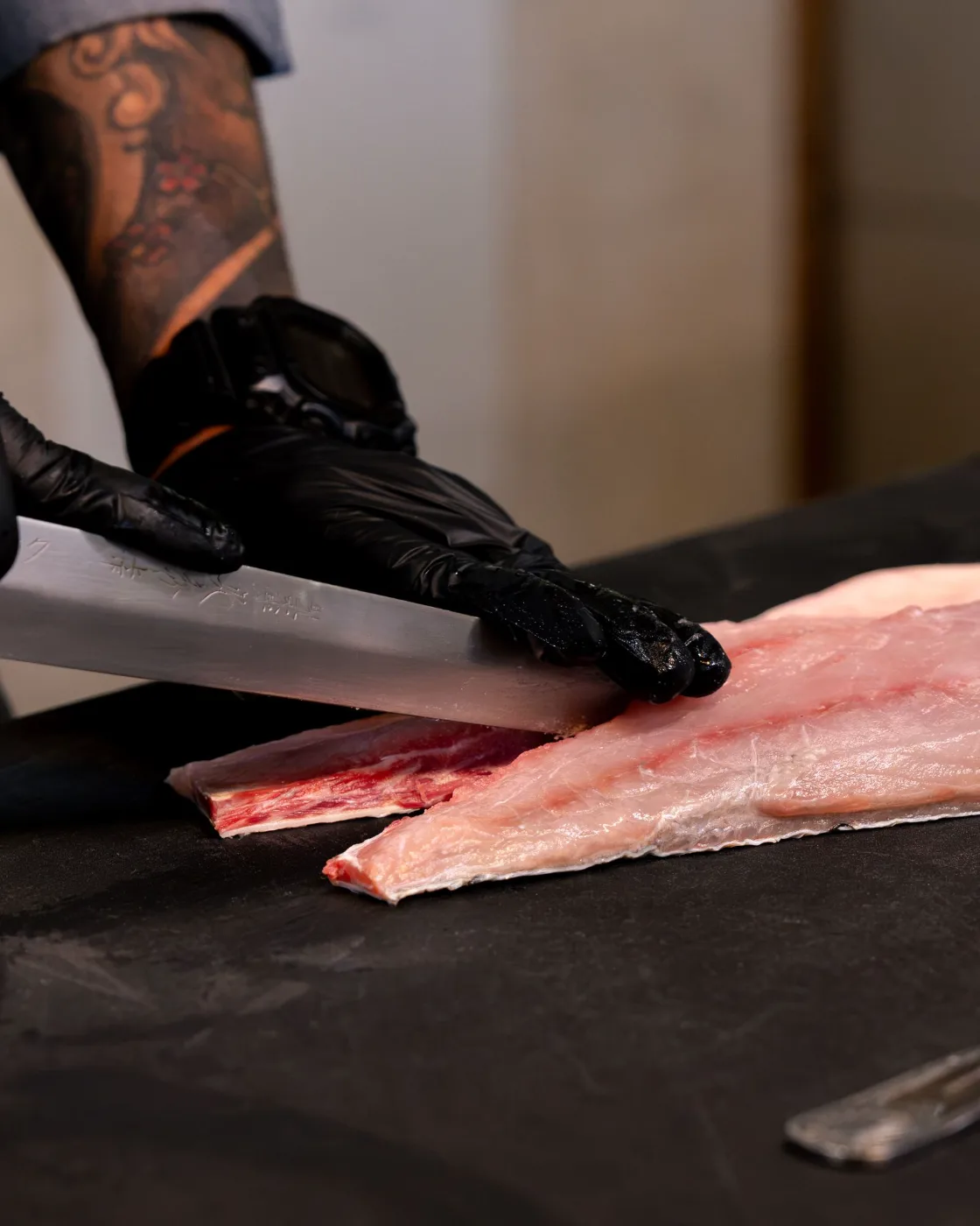 Breaking down fish with a Japanese knife for Nikkei tiradito at Esquina No. 525